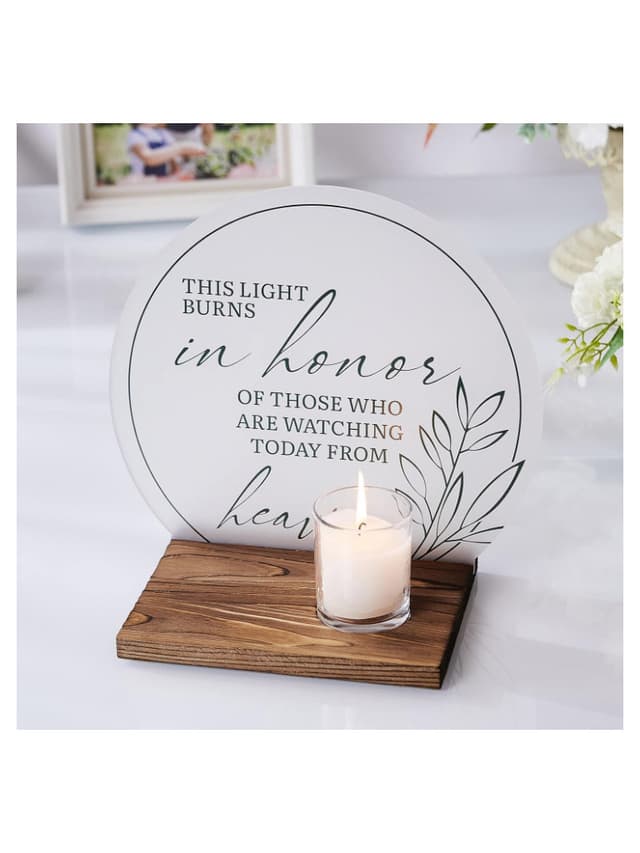 Wedding memorial sign featuring the message "This light burns in honor of those who are watching today from heaven," with an electric candle included, displayed on a wooden base.