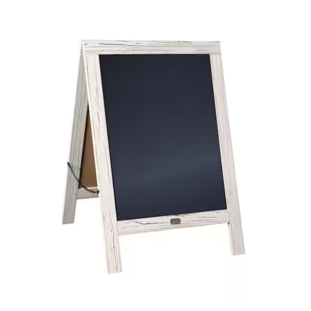 A rustic white A-frame chalkboard with a blank black surface, designed for displaying messages, standing upright with a chain for stability.