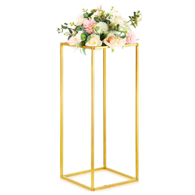 A gold flower rack featuring a modern geometric design, with a vibrant floral arrangement on top, including pink and cream roses, greenery, and other decorative flowers. The rack stands tall, showcasing its elegant structure.